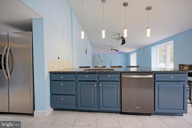 kitchen with light tile patterned floors, stainless steel appliances, hanging light fixtures, backsplash, and a sink