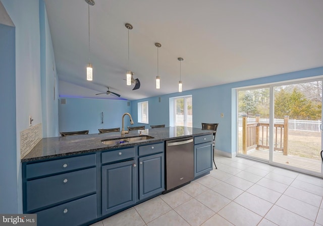 kitchen featuring a sink, light tile patterned floors, dark stone countertops, and dishwasher