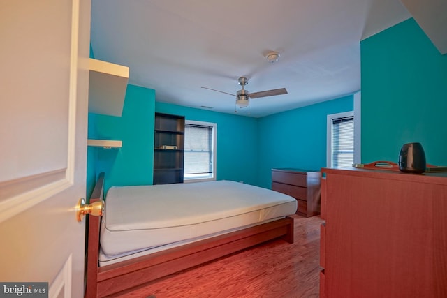 bedroom featuring wood finished floors and a ceiling fan