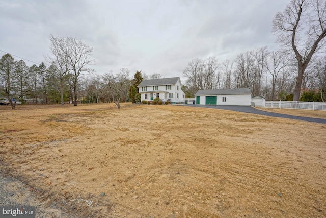 view of front facade with an outbuilding and fence