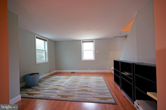 interior space with wood finished floors and baseboards