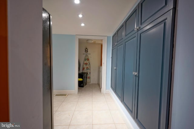 corridor with light tile patterned floors, baseboards, and recessed lighting