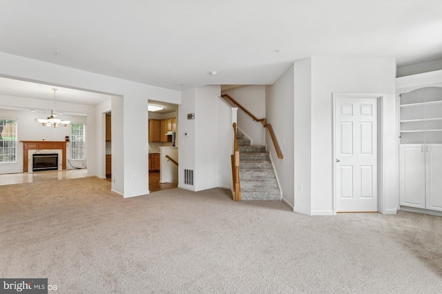 7315 Serenade Cir, Clinton, MD 20735 - unfurnished living room with carpet, stairway, a premium fireplace, a chandelier, and baseboards