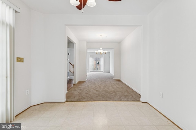 7315 Serenade Cir, Clinton, MD 20735 - corridor with light colored carpet, stairway, a chandelier, and baseboards