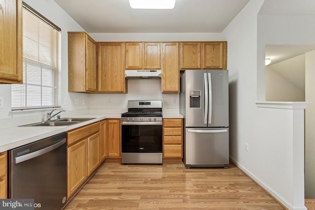 7315 Serenade Cir, Clinton, MD 20735 - kitchen with stainless steel appliances, under cabinet range hood, a sink, light countertops, and light wood-style flooring