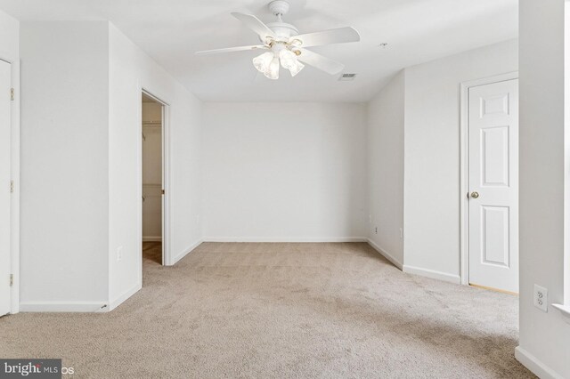 7315 Serenade Cir, Clinton, MD 20735 - unfurnished bedroom featuring carpet flooring, a spacious closet, baseboards, and a ceiling fan