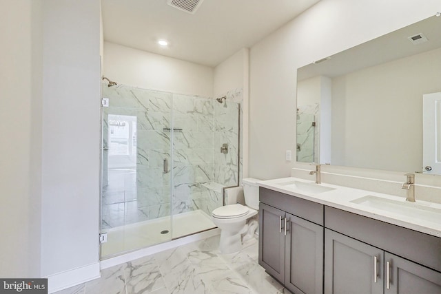 full bath featuring toilet, marble finish floor, a sink, and a marble finish shower