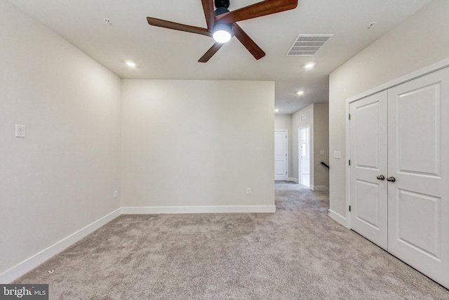 spare room with light colored carpet, visible vents, baseboards, and recessed lighting