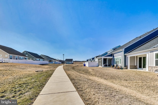 view of yard featuring a residential view and fence