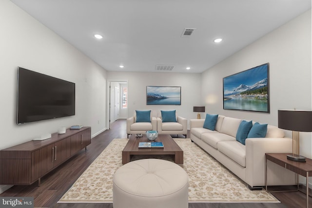 living area with visible vents, dark wood-style flooring, and recessed lighting