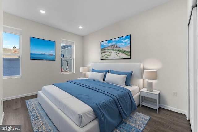 bedroom with baseboards, wood finished floors, and recessed lighting