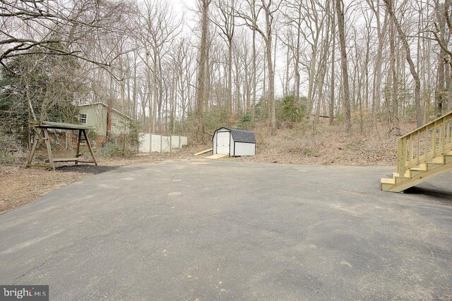 view of yard with a storage unit and an outbuilding