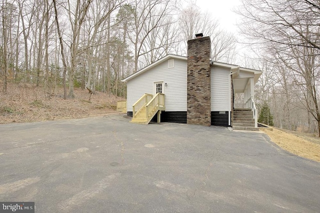 view of property exterior featuring a chimney