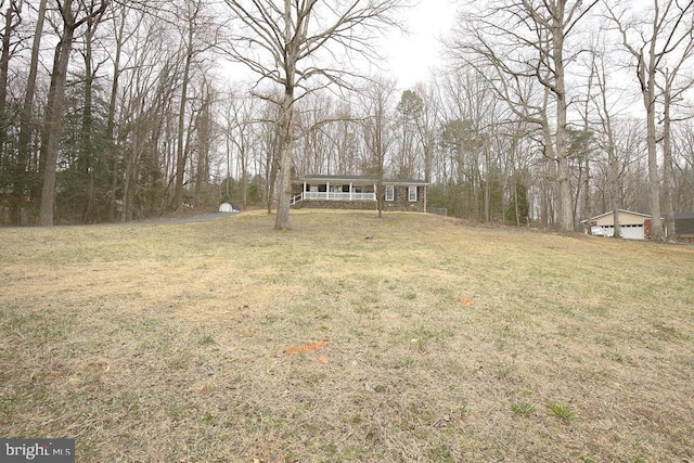 view of yard featuring a garage and a porch