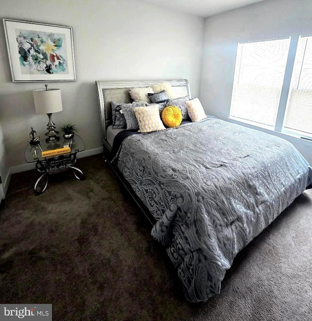 carpeted bedroom featuring baseboards