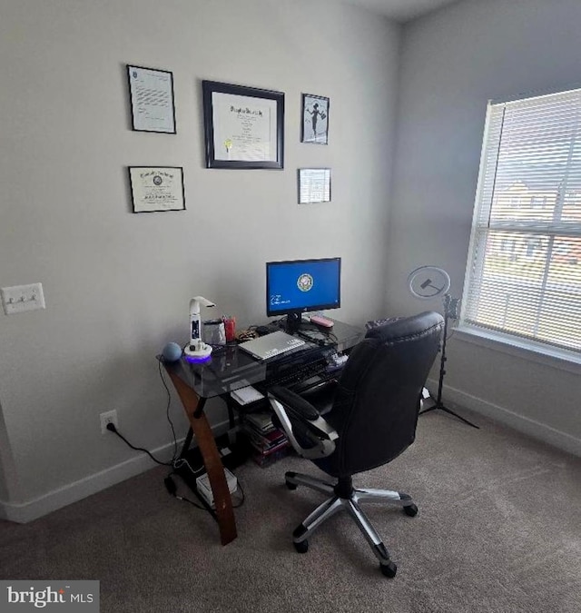 carpeted home office featuring baseboards