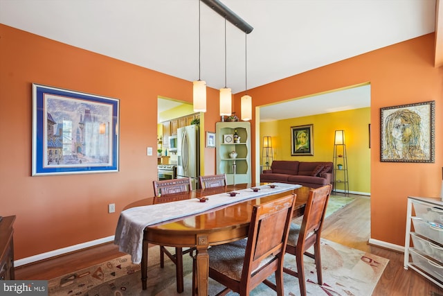 dining room with wood finished floors and baseboards