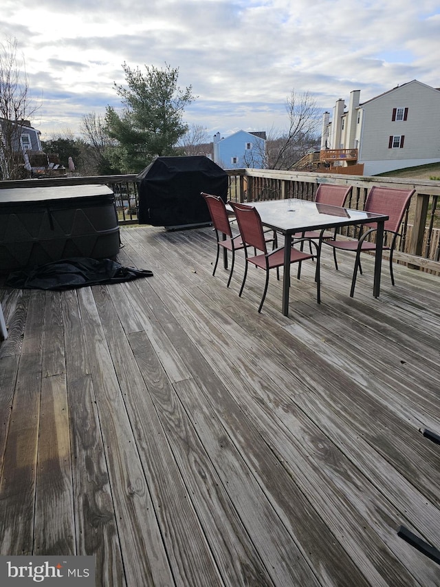 wooden terrace featuring grilling area and outdoor dining area