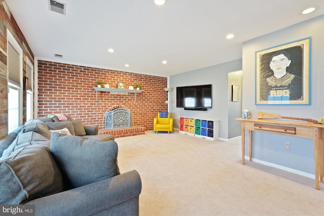 living area featuring visible vents, baseboards, a brick fireplace, and brick wall