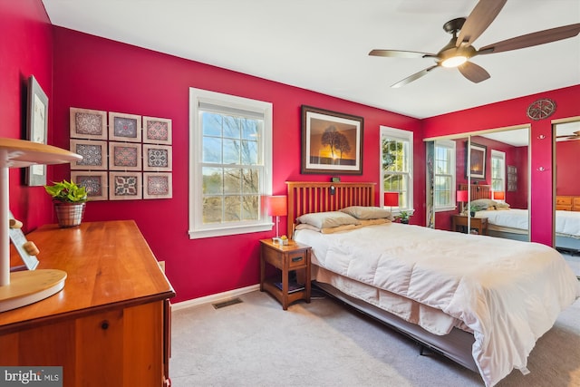 bedroom featuring baseboards, visible vents, multiple windows, and carpet floors