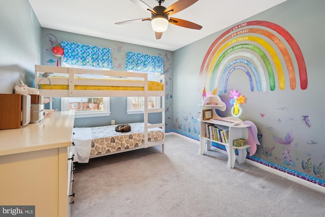 carpeted bedroom with a ceiling fan and baseboards