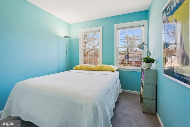 carpeted bedroom featuring baseboards