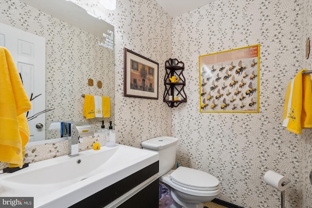 bathroom featuring toilet and vanity