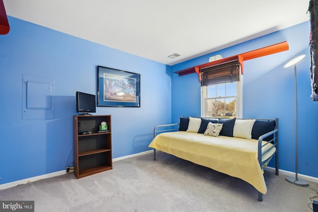 carpeted bedroom with electric panel, visible vents, and baseboards