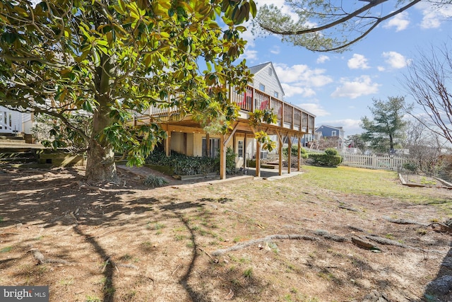 view of yard featuring a wooden deck and fence