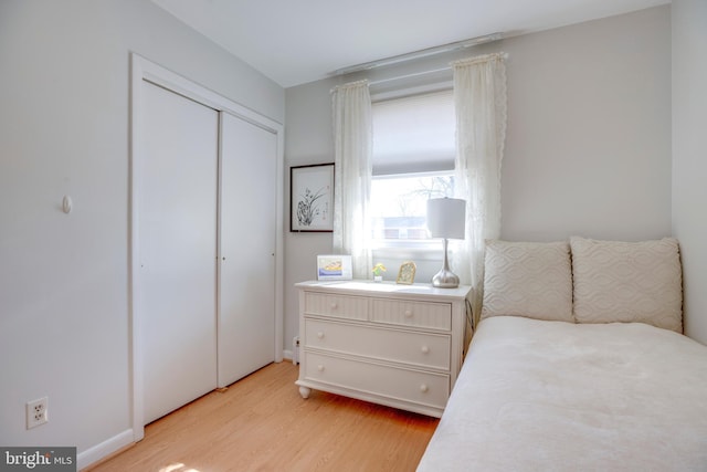 bedroom featuring light wood-style floors and a closet