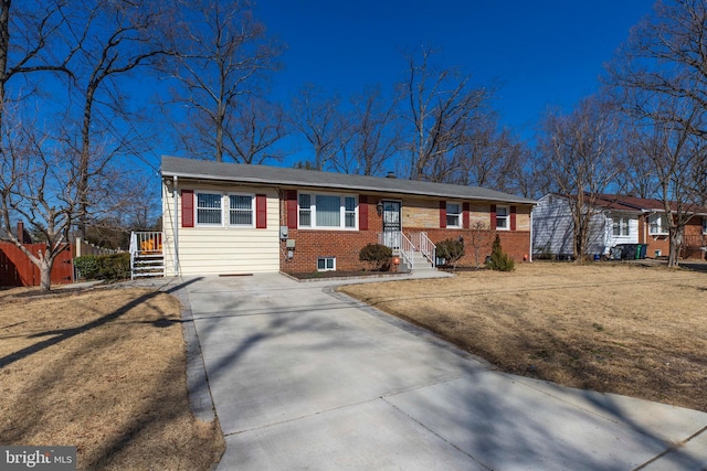 ranch-style home featuring brick siding and fence