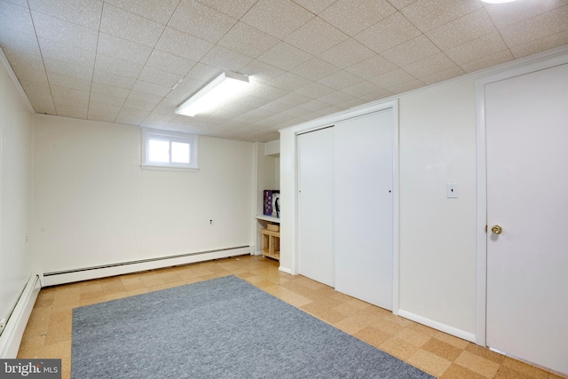 below grade area featuring baseboard heating and tile patterned floors