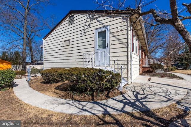 view of home's exterior with fence