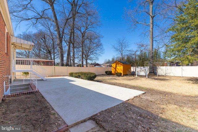 view of yard with a patio area, a fenced backyard, a shed, and an outdoor structure