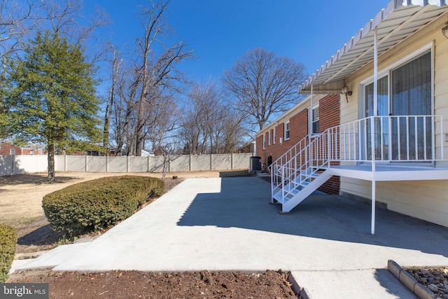 view of patio / terrace featuring central air condition unit and fence