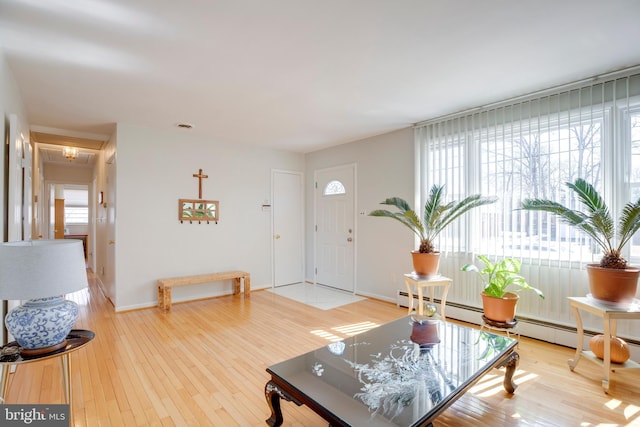 living area with light wood-type flooring and baseboards