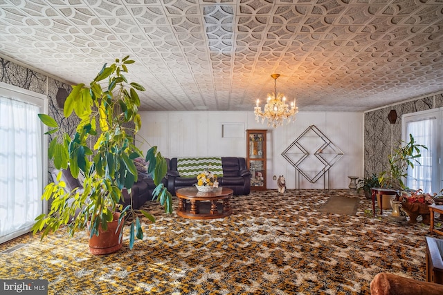 unfurnished living room featuring carpet floors and a chandelier