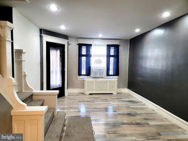 foyer featuring stairs, baseboards, wood finished floors, and recessed lighting