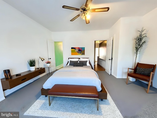 bedroom with ceiling fan and baseboards