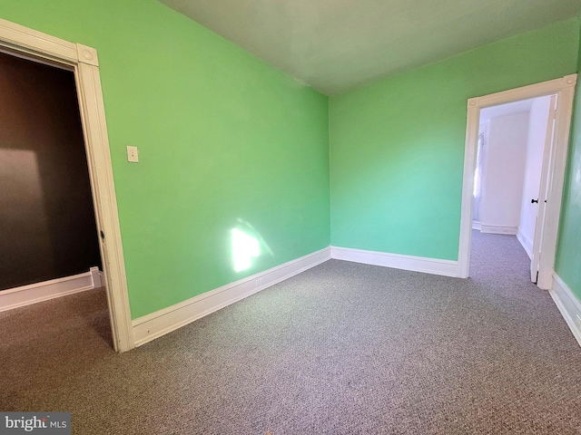 unfurnished bedroom featuring carpet and baseboards