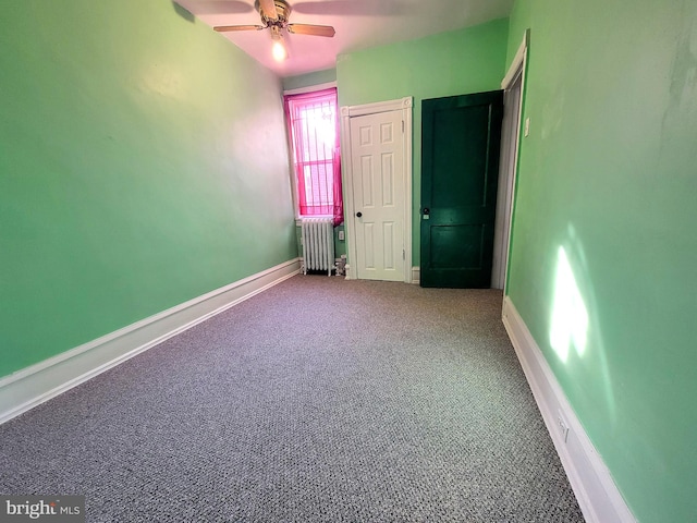 unfurnished bedroom with ceiling fan, radiator heating unit, carpet flooring, and baseboards