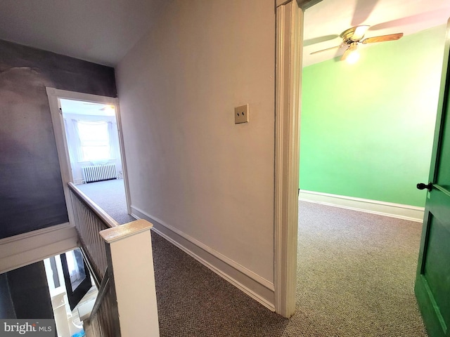 hallway with carpet flooring and baseboards