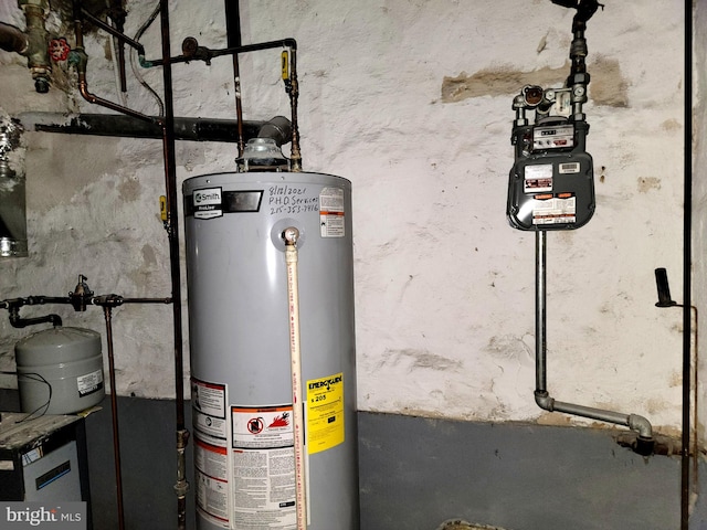 utility room featuring water heater