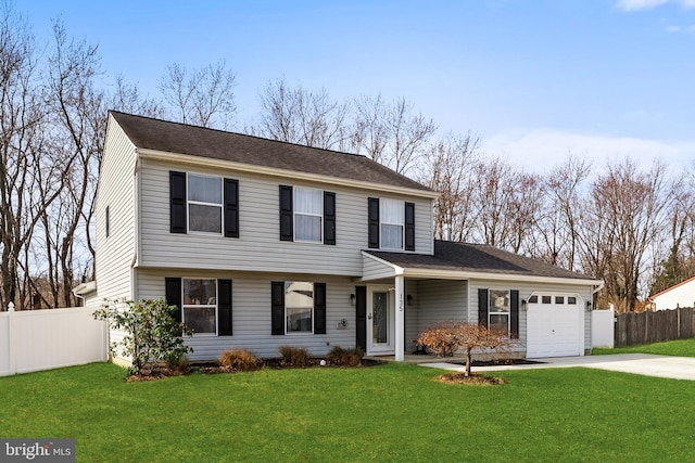 colonial-style house with driveway, an attached garage, a front lawn, and fence