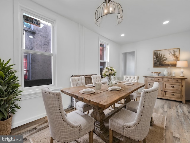 dining room featuring recessed lighting, a notable chandelier, and light wood-style flooring