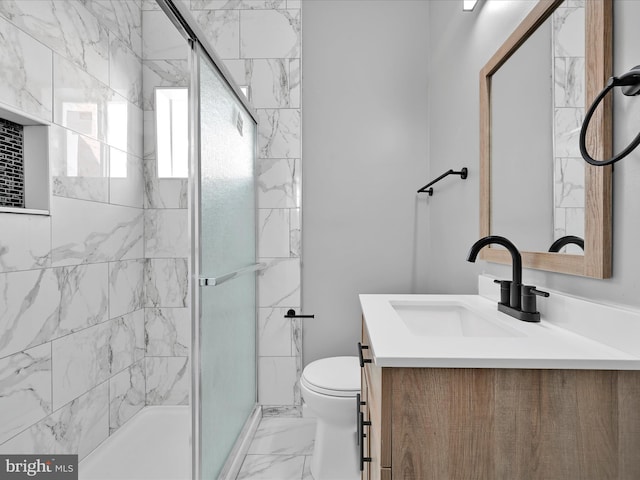 full bath featuring vanity, a shower stall, toilet, and marble finish floor