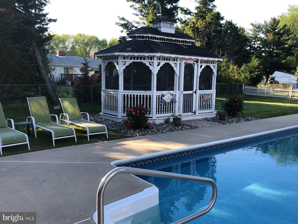 view of pool with a fenced in pool, a lawn, a gazebo, a patio area, and fence