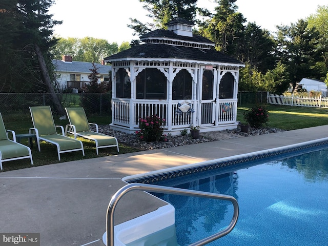 view of pool with a fenced in pool, a lawn, a gazebo, a patio area, and fence