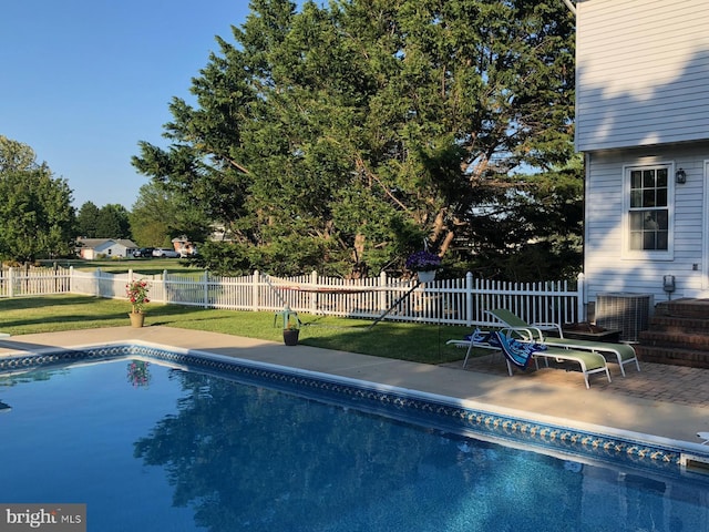 view of pool featuring a fenced in pool, fence, a lawn, and a patio