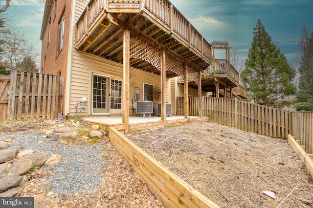 back of property featuring central AC unit, stairway, a patio area, and a fenced backyard